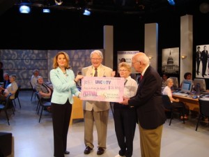 Shannon Vickery, left, receives Carolina Meadows' check from residents Don Stedman, Helen Stedman and Roy Carroll as residents and staff look on.