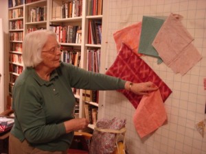 Anne Jones designs a new quilt by arranging fabric swatches. Photo: Jim Borden