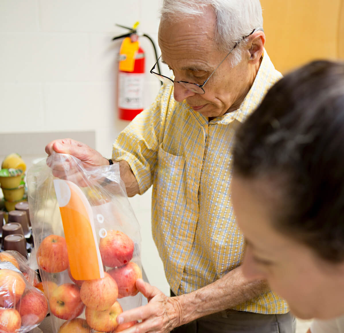 A resident at Carolina Meadows helping out with a community food